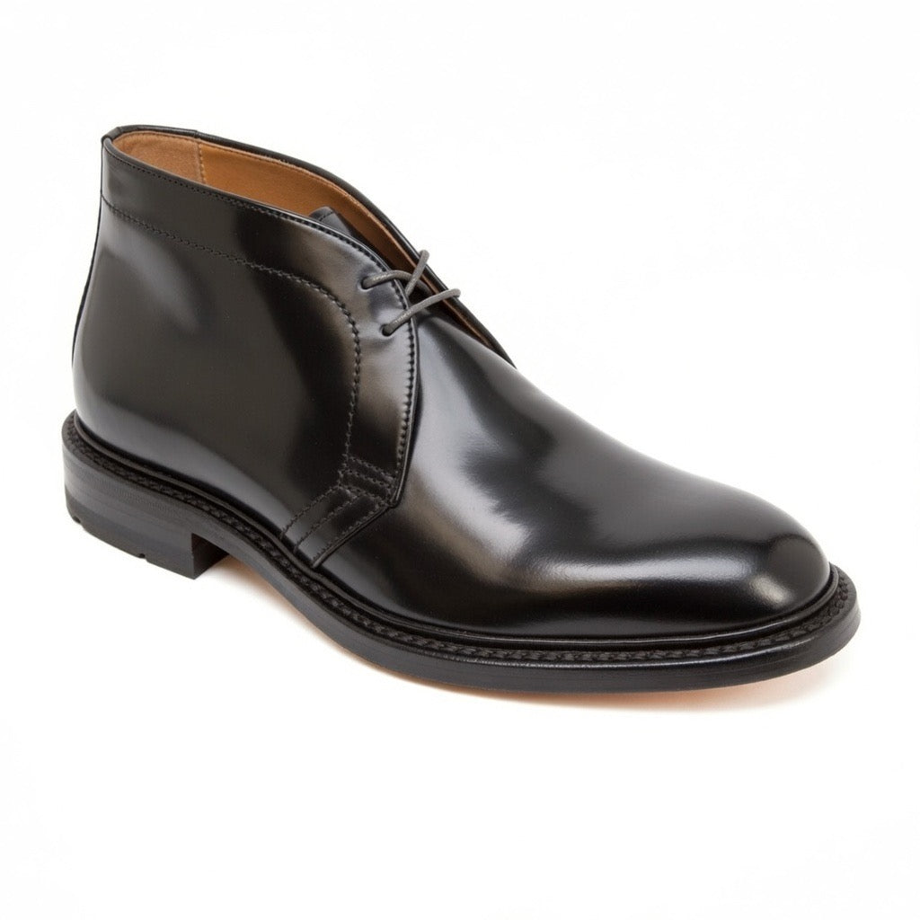 A single Alden Madison 1340C Chukka Boot in Black Shell Cordovan with laces, polished finish, low heel, Commando Sole, and stitched detailing around the sole is displayed on a white background.