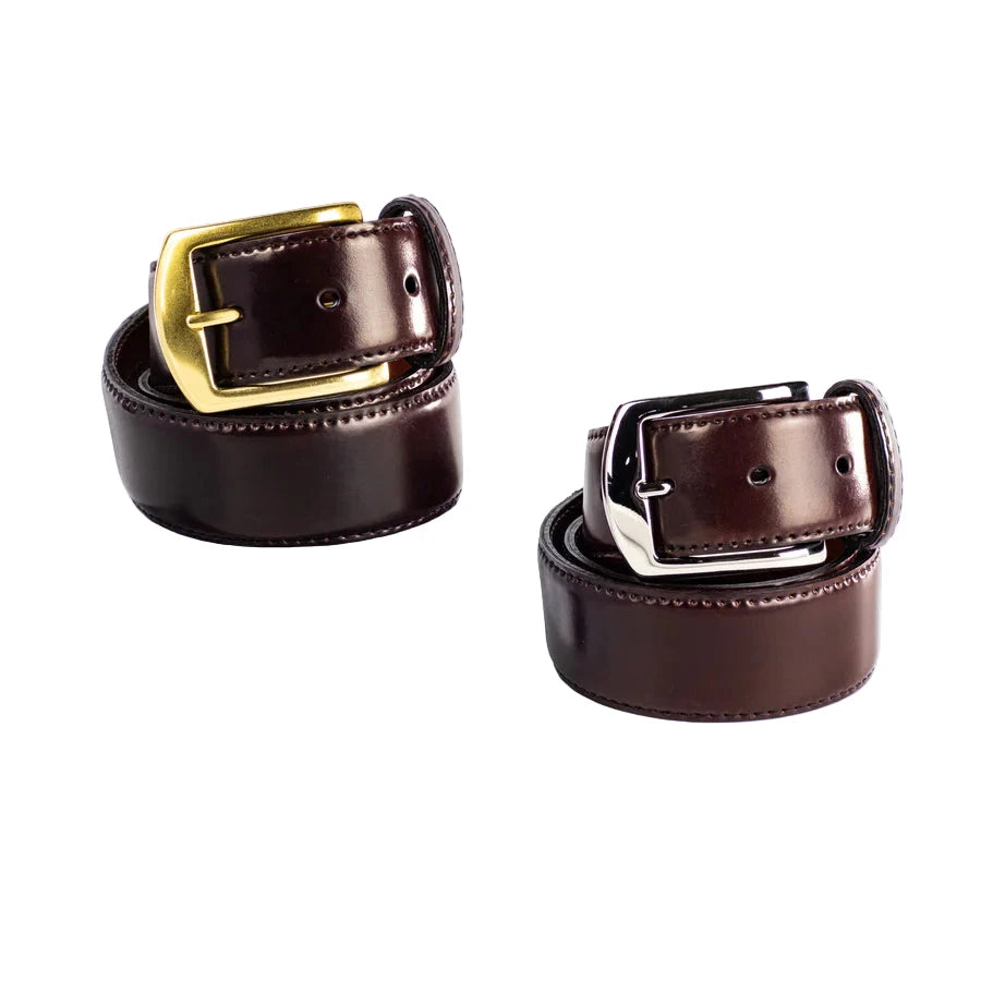 Two rolled-up Alden Madison MB 5918 - Alden 38mm Color 8 Shell Cordovan Belts, one with a gold and the other with a silver buckle, are displayed side by side on a white background. Each is 38mm wide and made in the USA.
