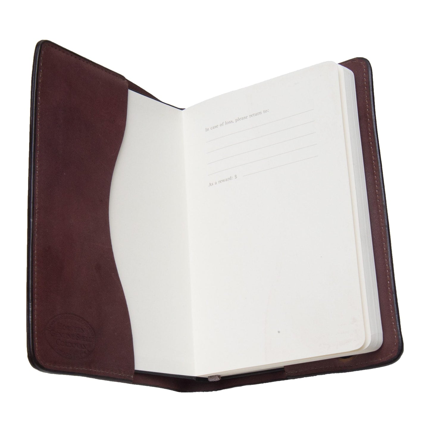 An open notebook displaying blank pages, including a section for contact details on the right, is elegantly enclosed in an Alden Madison Moleskine Notebook Cover made from Horween shell cordovan.