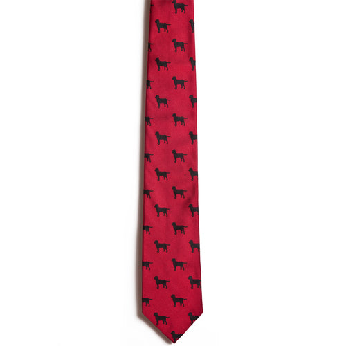 The Alden Madison Black Labrador Retriever tie is a red silk accessory with a pattern of small black dog silhouettes—ideal for any fan of Black Labs.