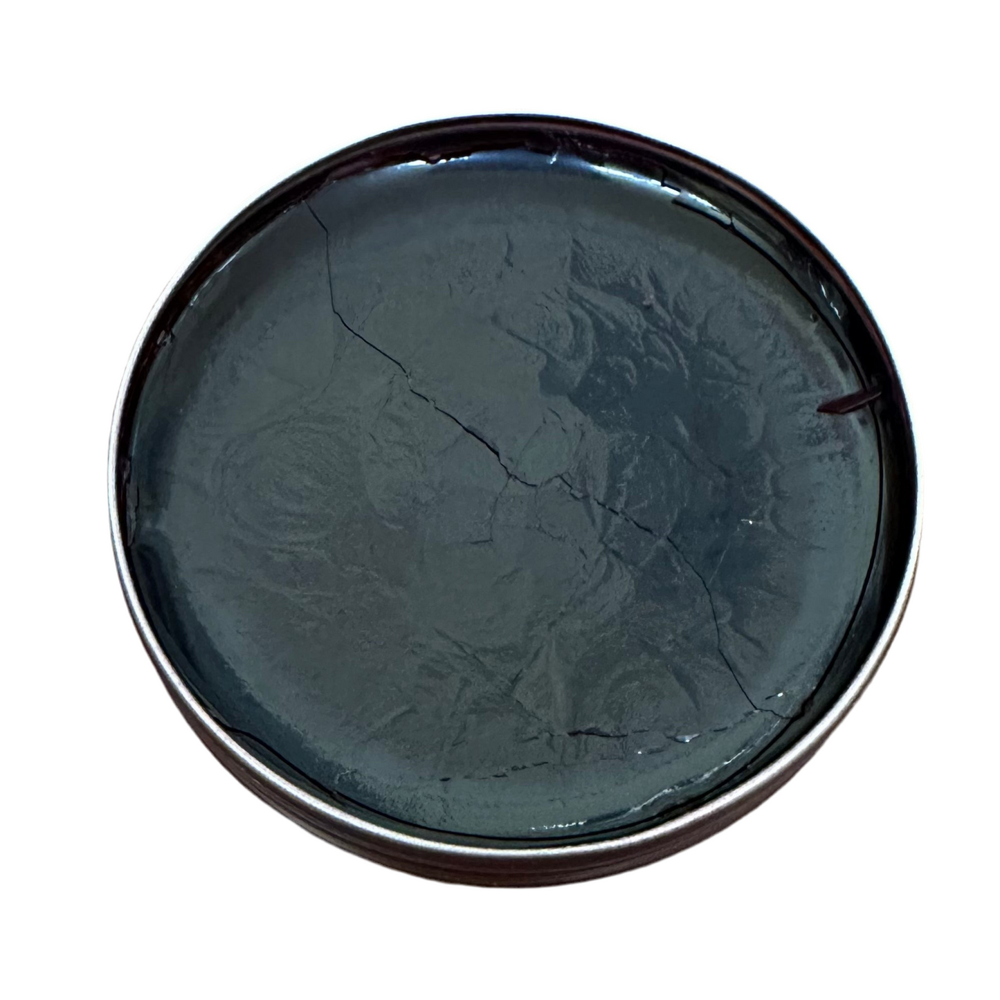 Alden Madisons Saphir Pate De Luxe comes in a round metal tin filled with dark, cracked, glossy wax polish. Its uneven, reflective surface shows lines and imperfections. Presented against a plain white background.