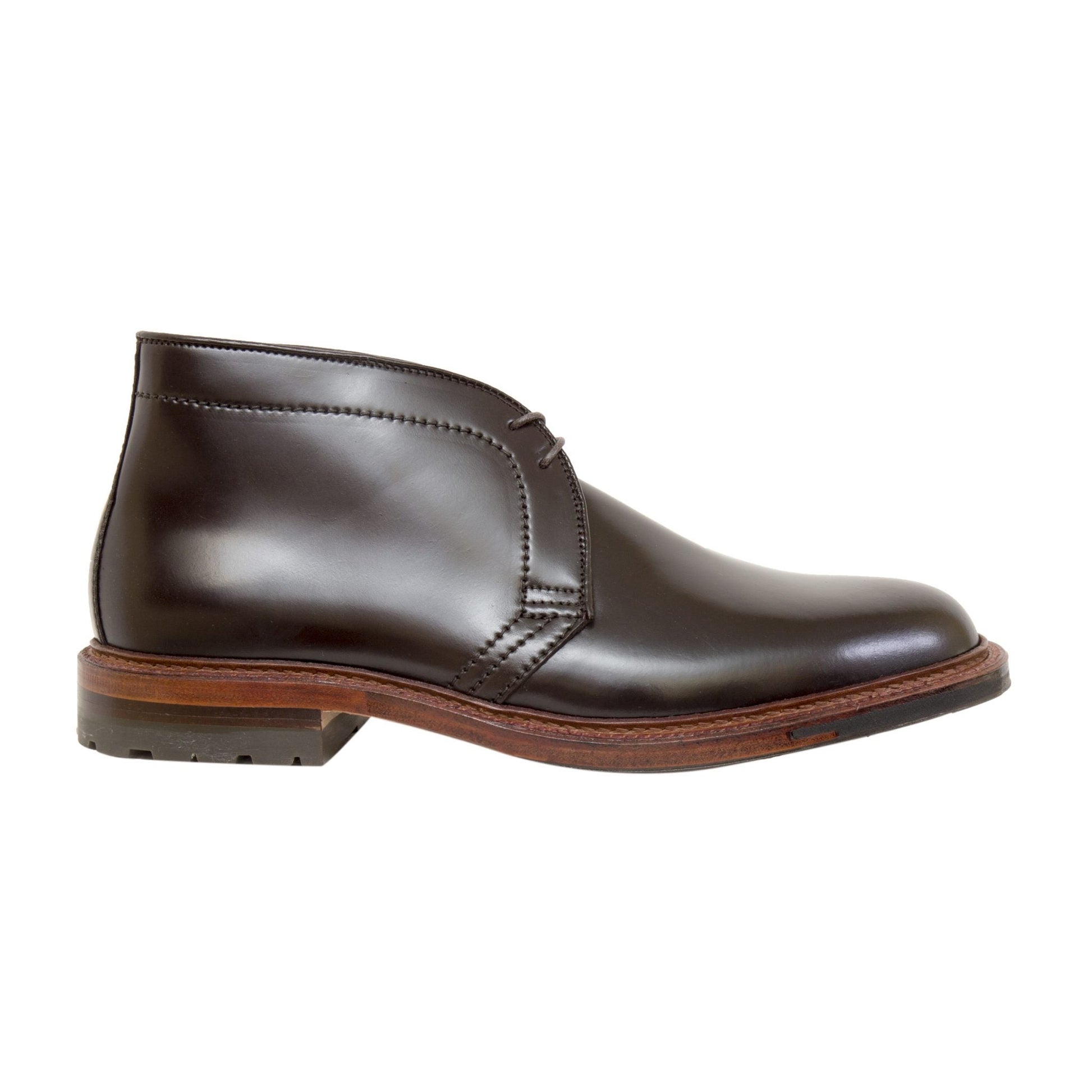 The D5706C - Antique Chukka Boot by Alden Madison showcases a sleek design in dark brown Color 8 Shell Cordovan with minimalist stitching, rounded toe, and wooden sole with antique edging, polished to perfection, displayed from the side on a white background.