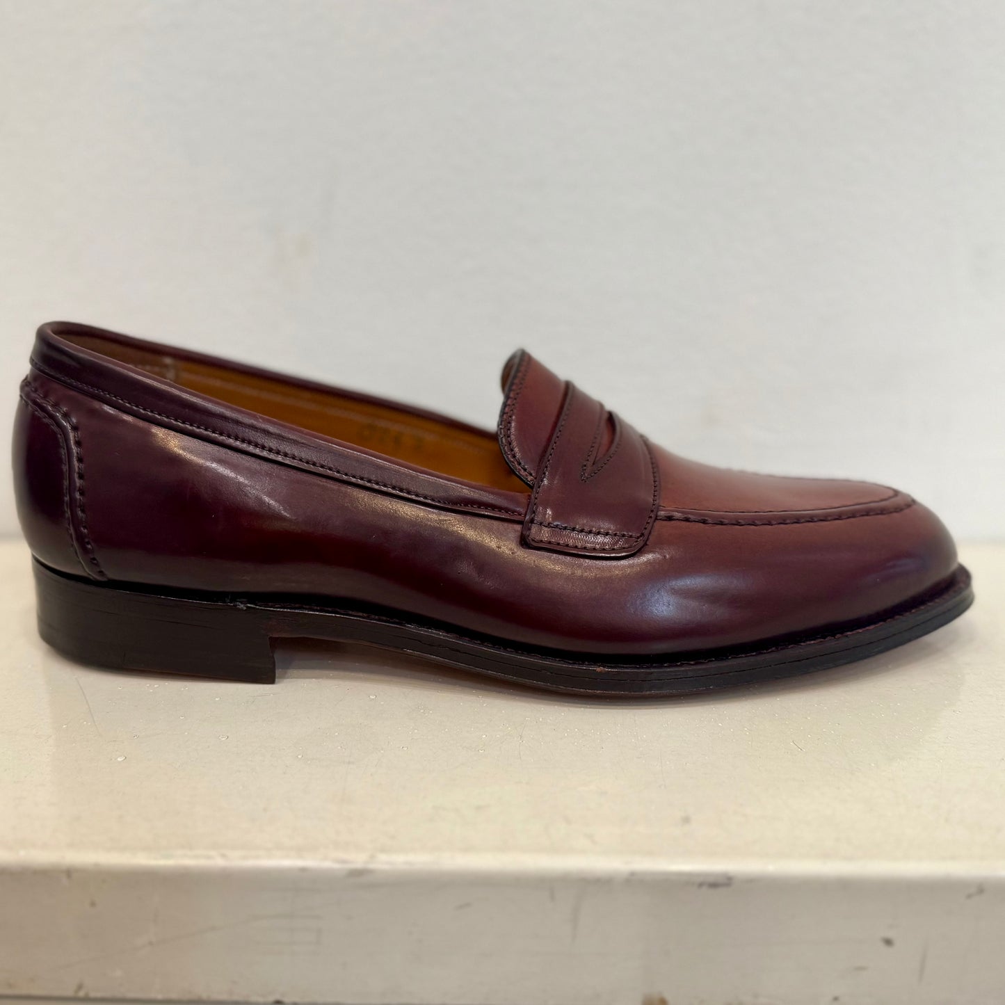 The ALDEN SHOES 5750 - Higher Vamp "Midtown" Slip On in Color 8 is showcased with a polished finish on a light surface and plain white background.