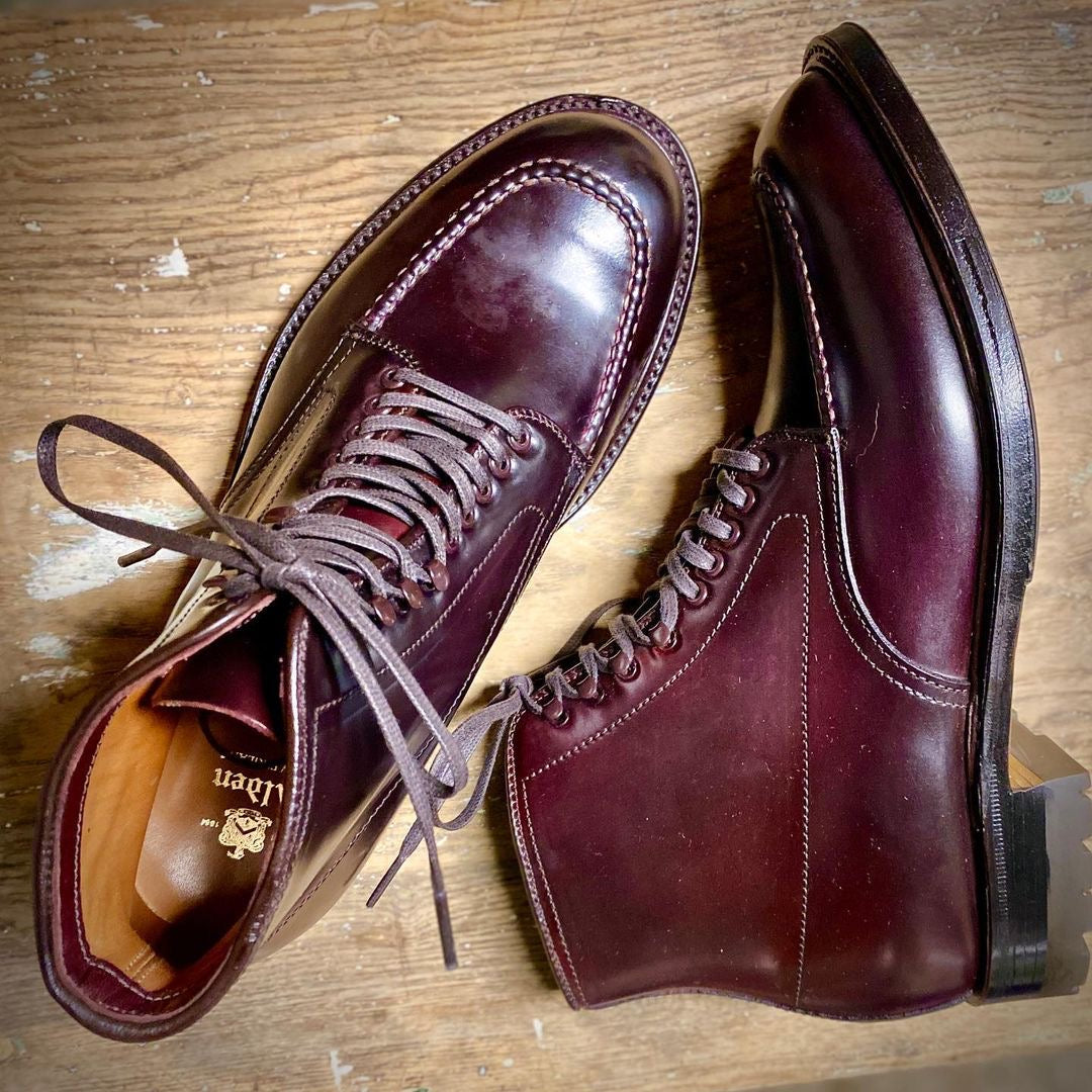 The Alden Madison 40508HC - Color 8 Shell Indy Boot features polished burgundy leather with laces, a Truebalance Last, visible stitching, and a brand logo on the insole. They are showcased on a wooden floor and come with a Commando Sole.