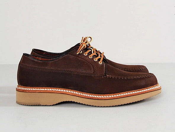 The ALDEN SHOES 73980 Tobacco Chamois Ranger Mocc with Wedge, featuring brown leather, tan wedge soles, and light brown laces, is shown side by side on a light gray surface.