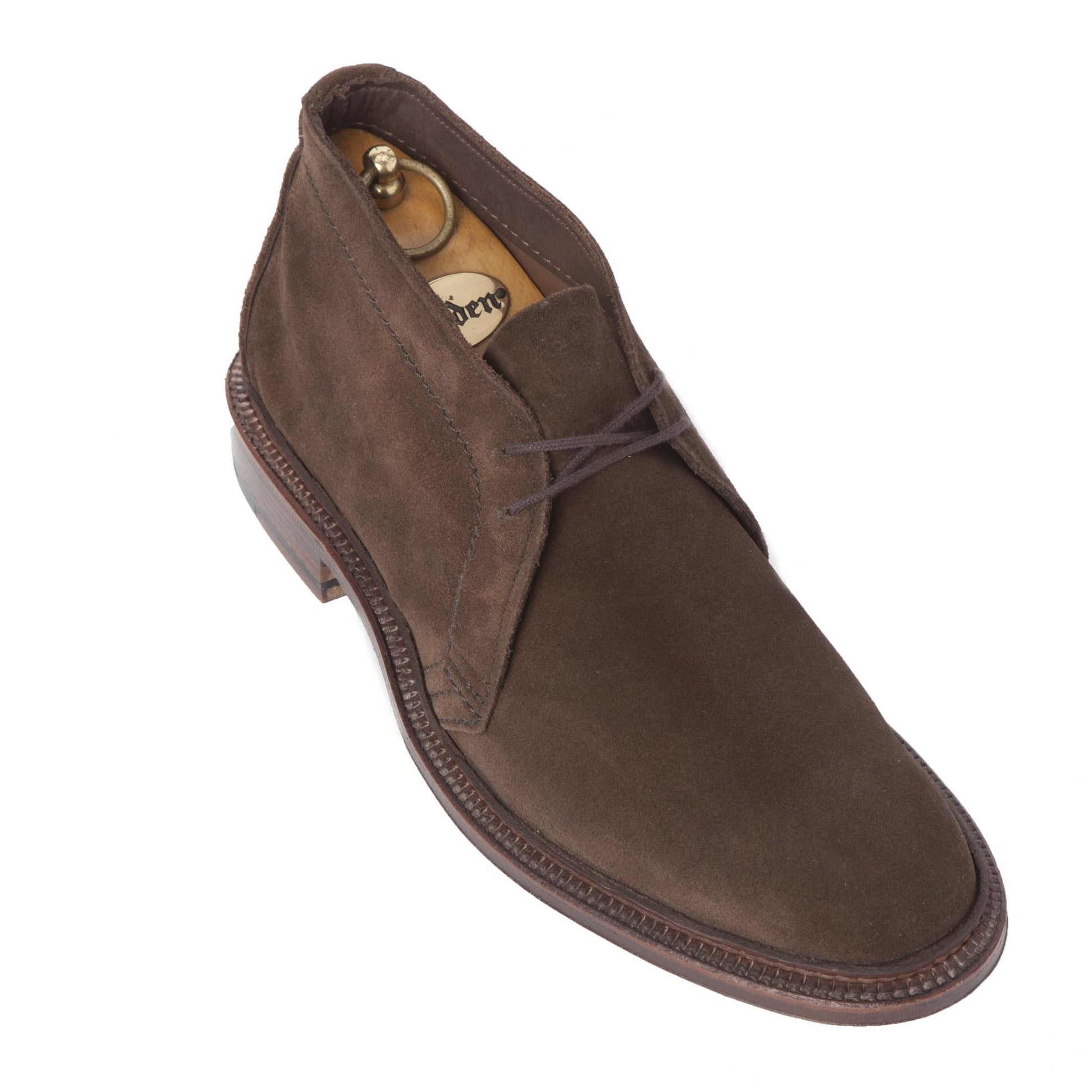 The Alden Madison 1492 - Unlined Chukka in Brown Suede, shown with laces on the Leydon Last and a Single Flex Leather Sole, features a wooden shoe tree insert against a white background.