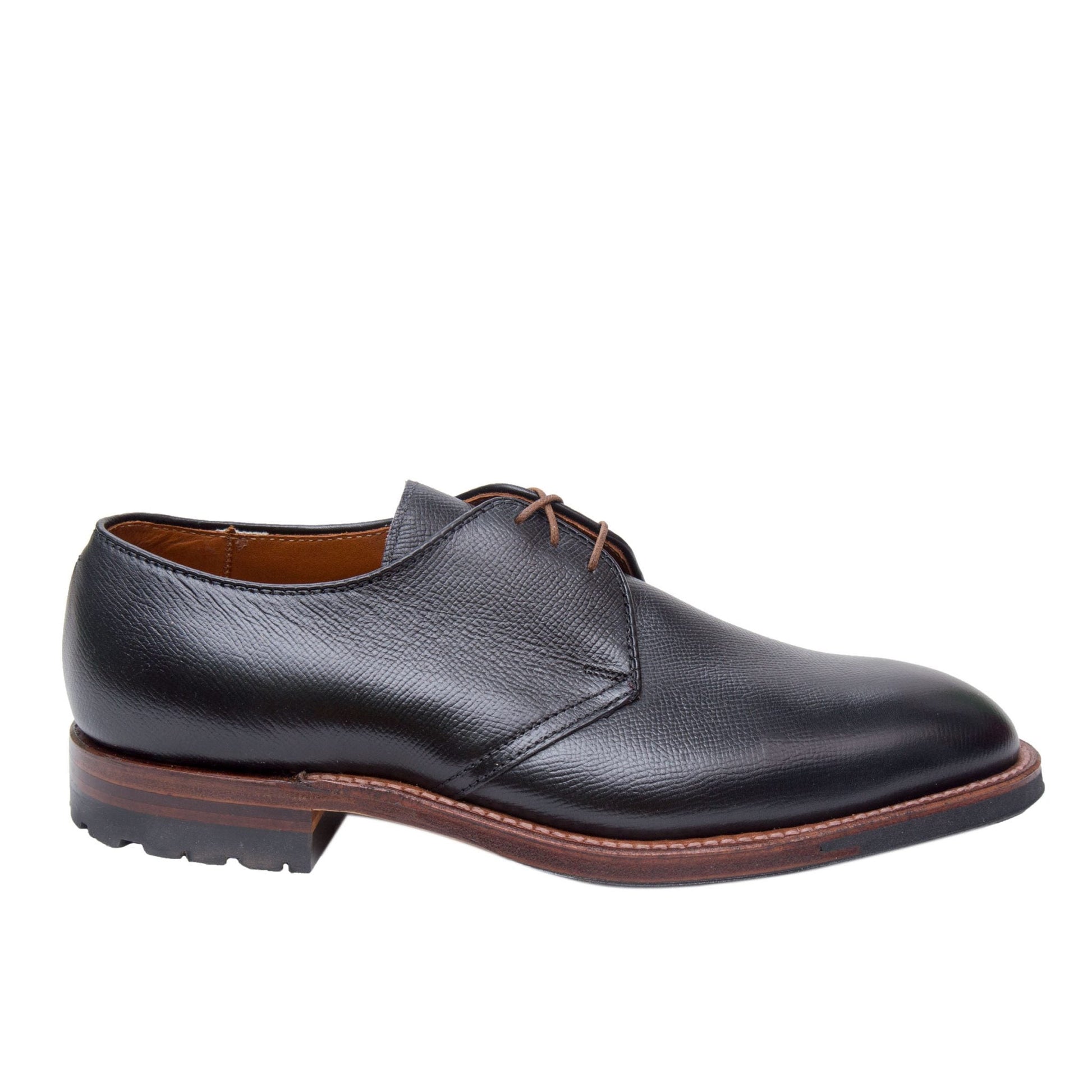 The Alden Madison 940C - 3 Eye Dutton features a black Alpine Grain Calfskin exterior with brown laces and a textured finish, set on a sturdy dark brown Commando Sole with slight tread, all showcased against a plain white background.