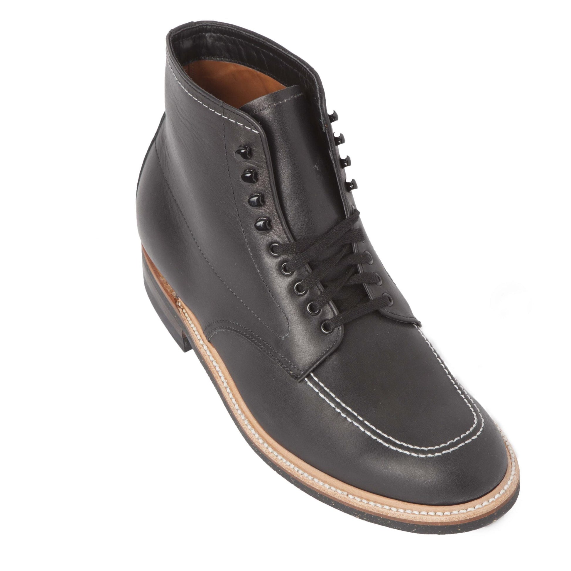 The Alden Madison 401 - Indy Boot in Black Chromexcel features black leather, black laces and eyelets, white stitching on the toe and around the Neoprene cork sole, plus tan and black accents. The boots are shown angled against a white background.