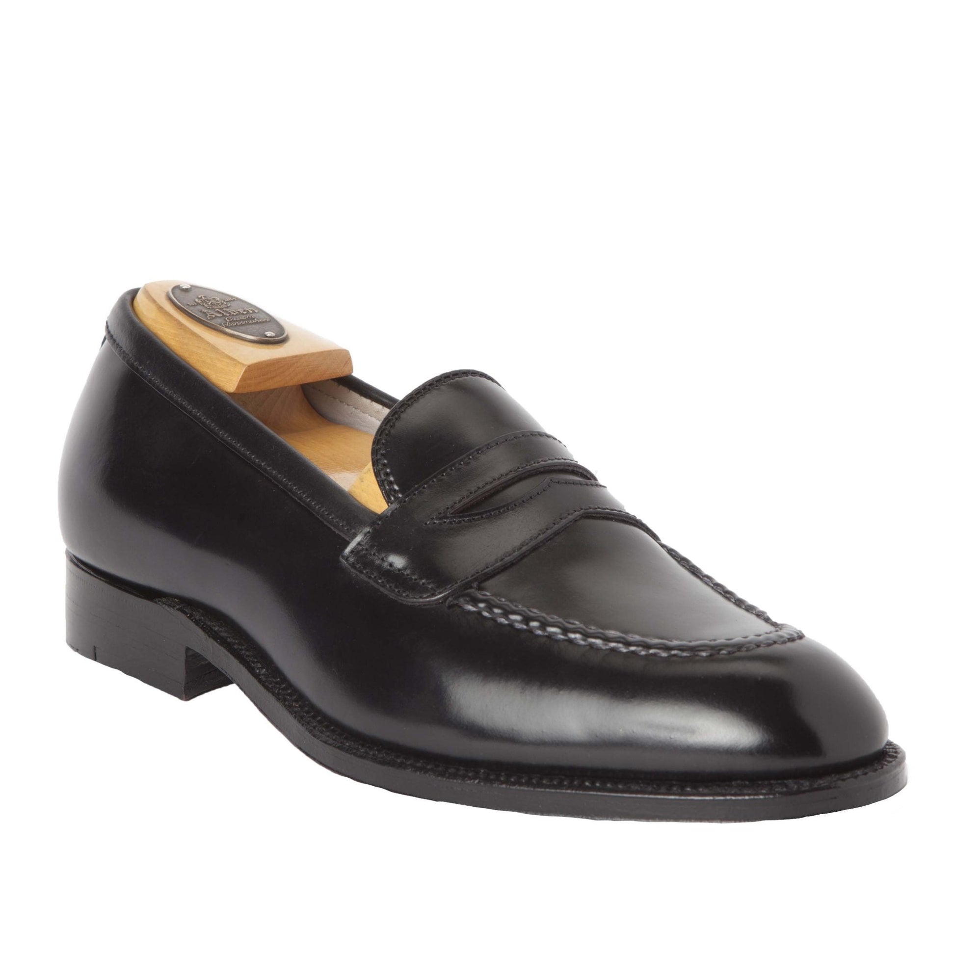 The Alden Madison 67269 High Vamp Loafer in Black Shell Cordovan features a stitched apron toe, single oak leather sole, and is displayed with a wooden shoe tree inside.