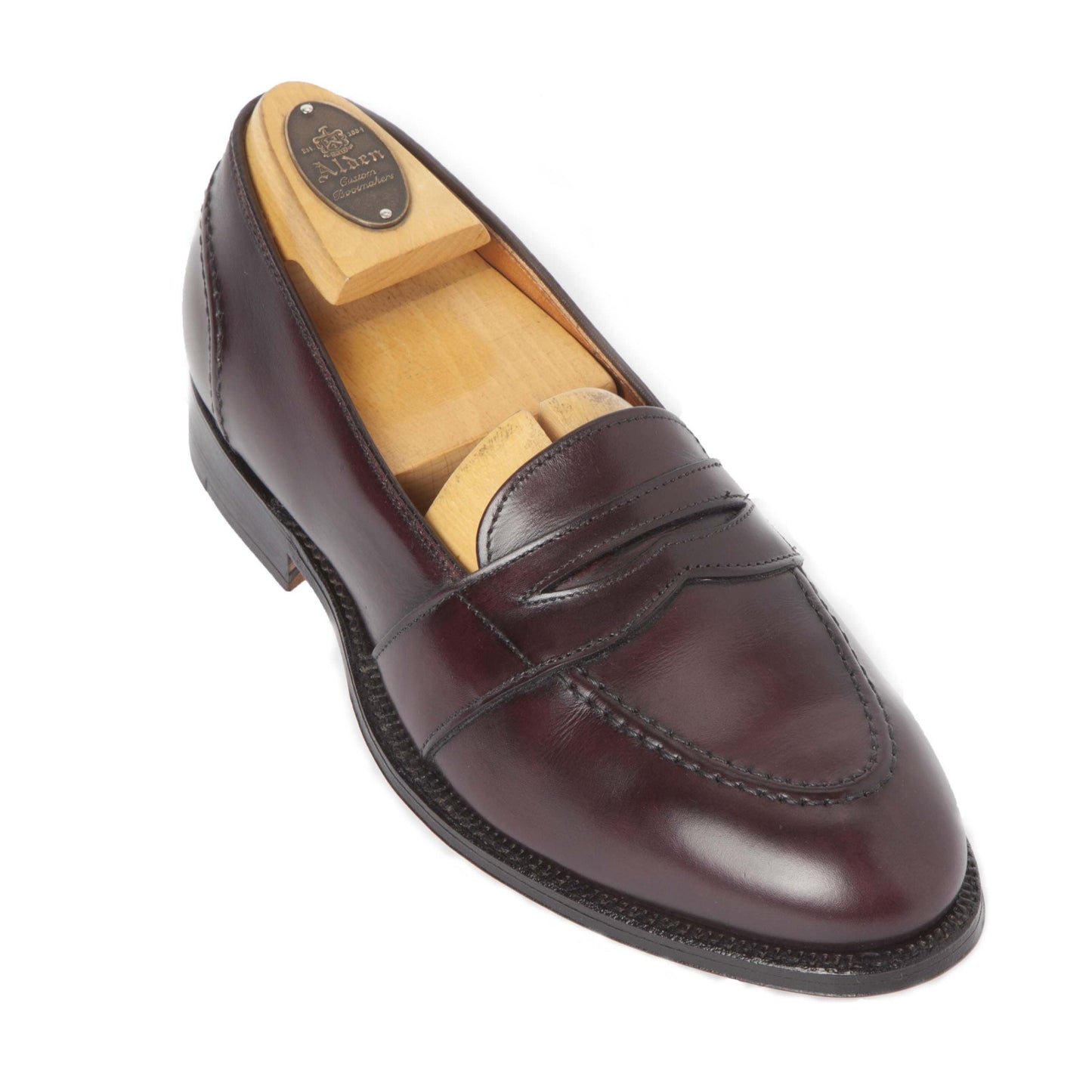 The Alden Madison 683 Full Strap Loafer in burgundy calfskin features a sleek profile, leather sole, and comes with a wooden shoe tree. Shown from the side against a white background.