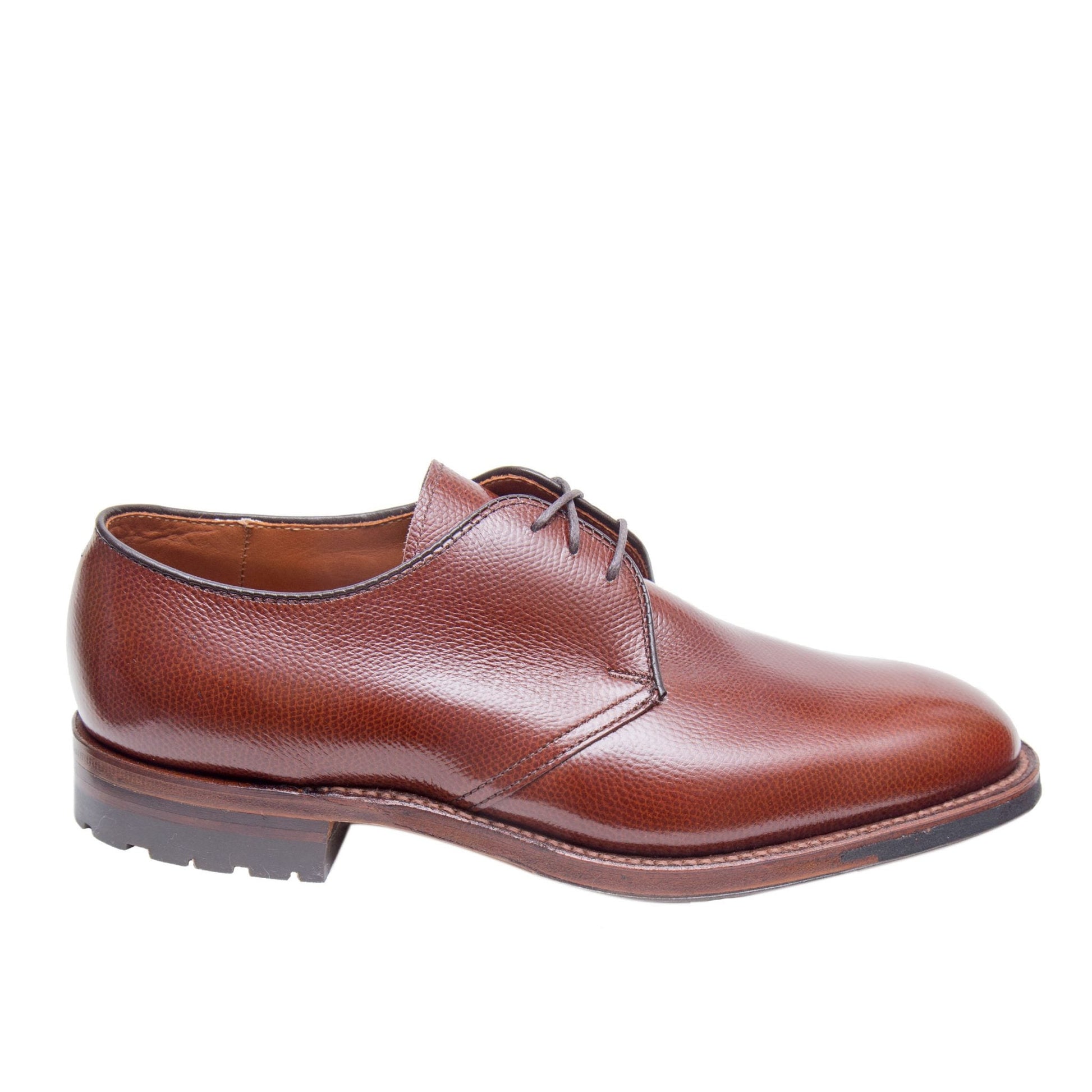 Alden Madison's 942C - 3 Eye Dutton in Brown Alpine Grain, a single brown leather dress shoe with a rounded toe and textured calfskin, is shown in profile on a white background.