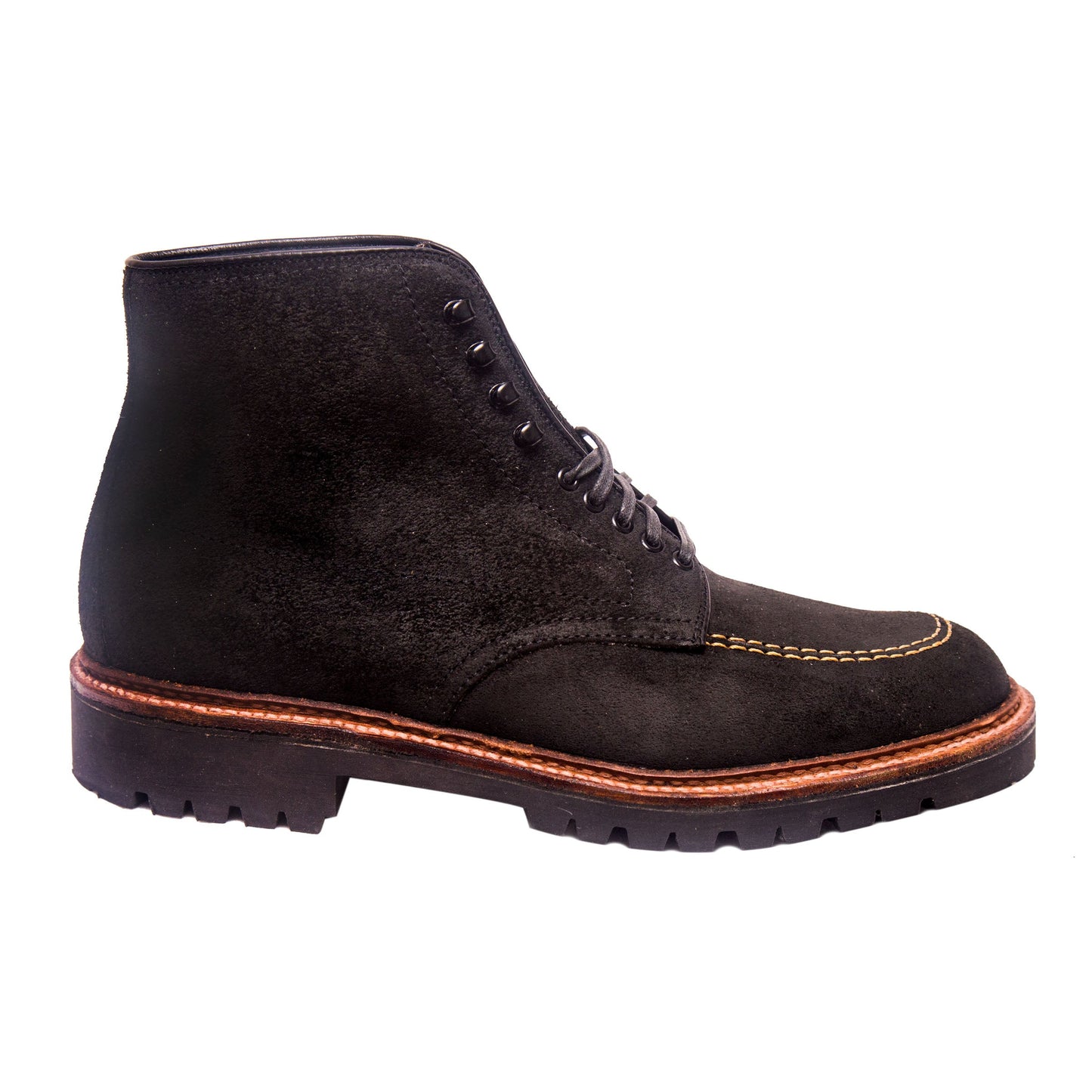 The D9916H Indy Boot in Earth Reverse Chamois by Alden Madison is a black suede ankle boot with brown stitching, Speed Hooks, Vibram Heavy Lug Outsole, lace-up design, and contrasting brown welt. Displayed against a white background, it exudes rugged elegance.