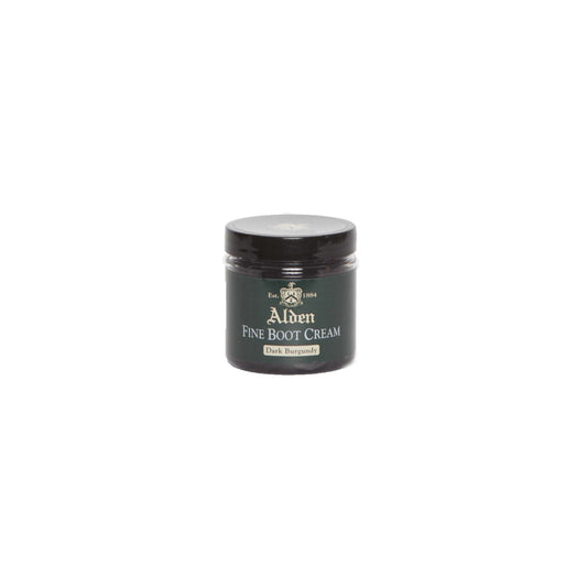 A small jar of Alden Boot Cream by Alden Madison, in Dark Burgundy, ideal for enhancing calfskin leathers. It has a black lid and label with white and gold text, featuring a crest logo. The jar is centered on a plain white background.