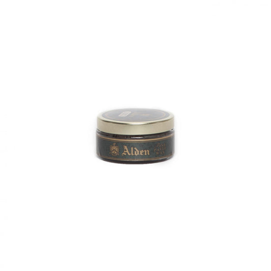 A small, round tin with a beige lid and dark body sits centered on a white background. Its labeled Alden Paste Wax, showcasing the prestigious Alden Madison logo and text on the side.