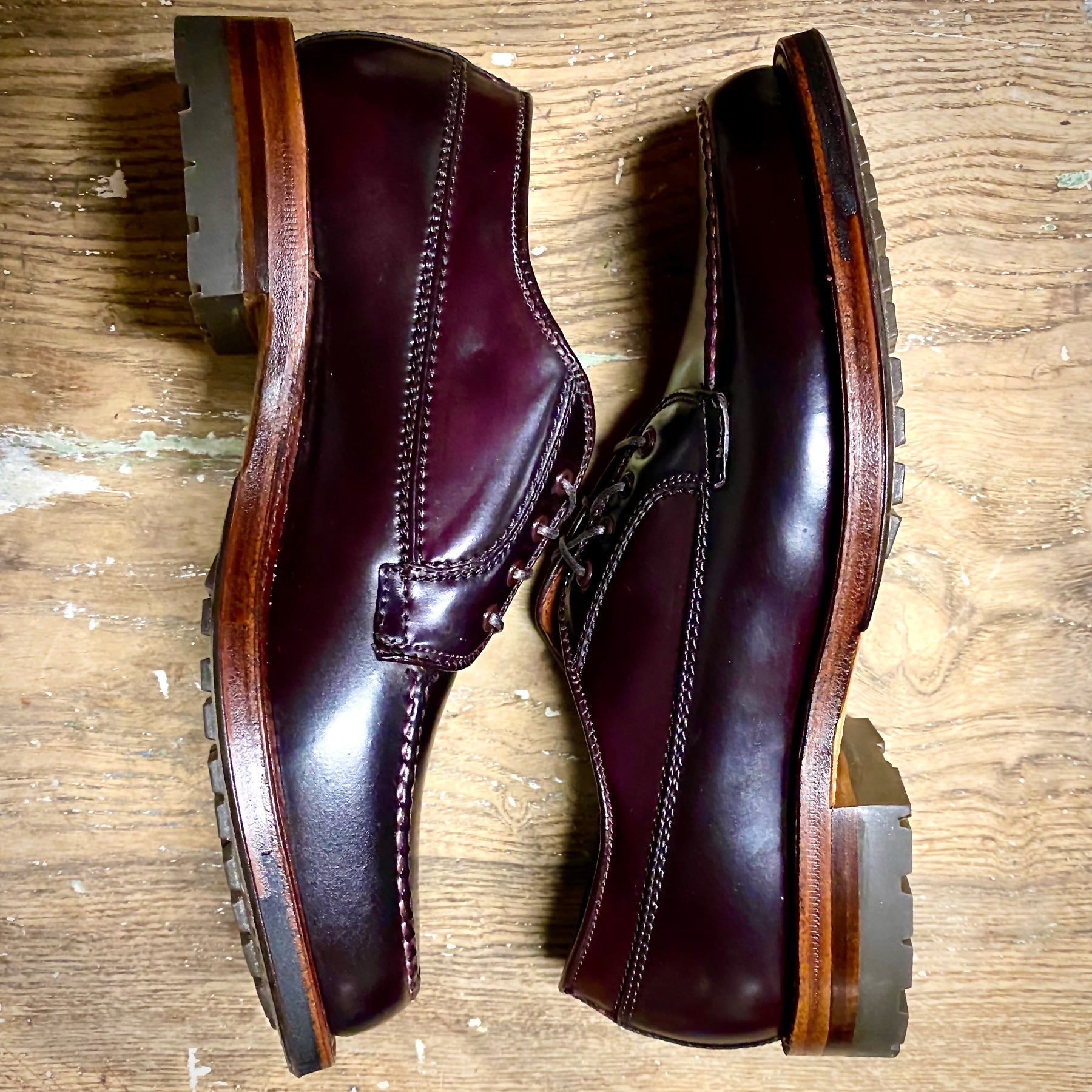 A pair of Alden Madison D9613C - Ranger Mocc in Color 8 Shell Cordovan with dark laces and thick Commando Soles, placed side by side on a wooden floor.