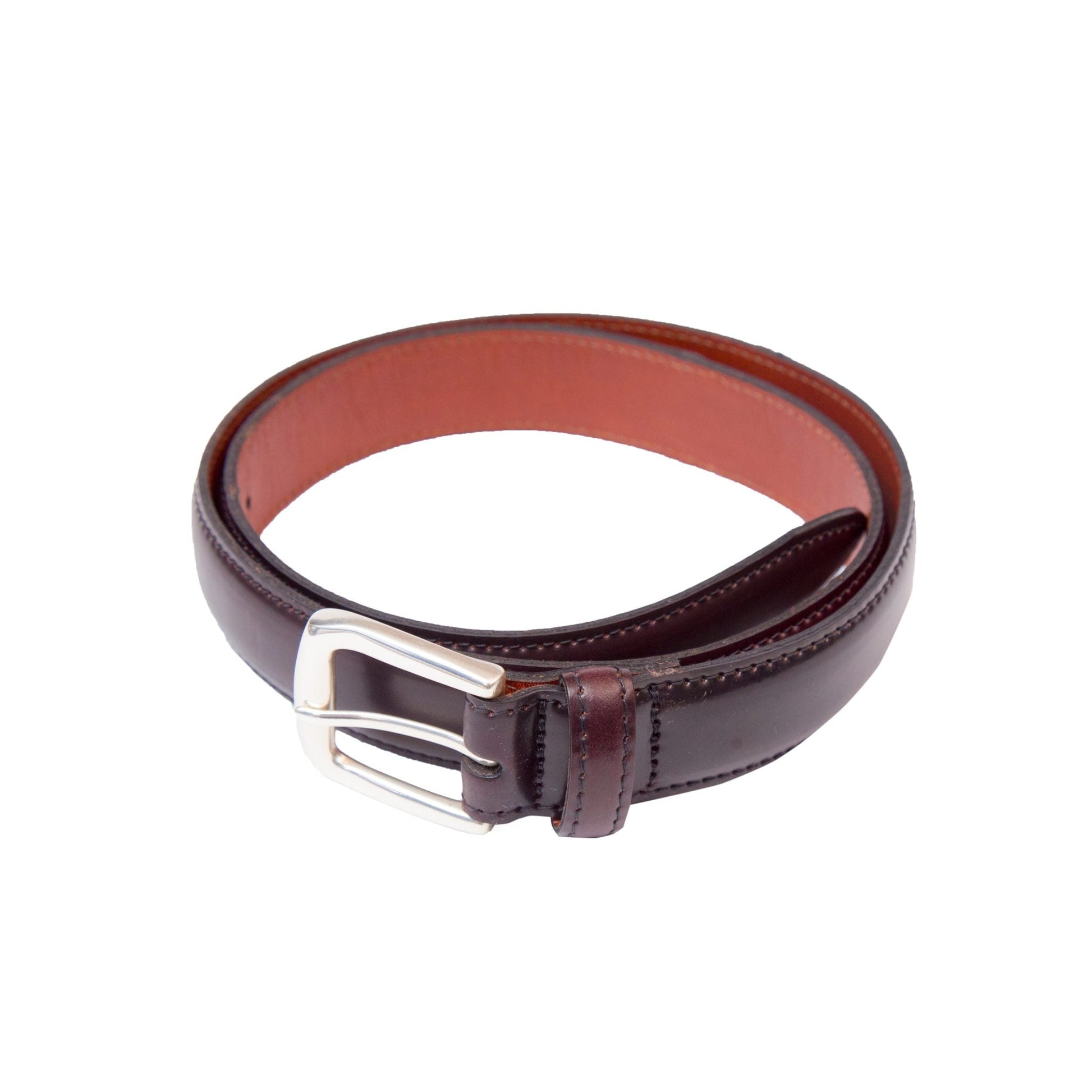 A rolled-up Alden Madison A001 - Color 8 leather belt, crafted from Horween Shell Cordovan, features a sleek nickel buckle and is set against a white background. The inner side showcases a lighter brown hue, and the belt measures 30mm in width.