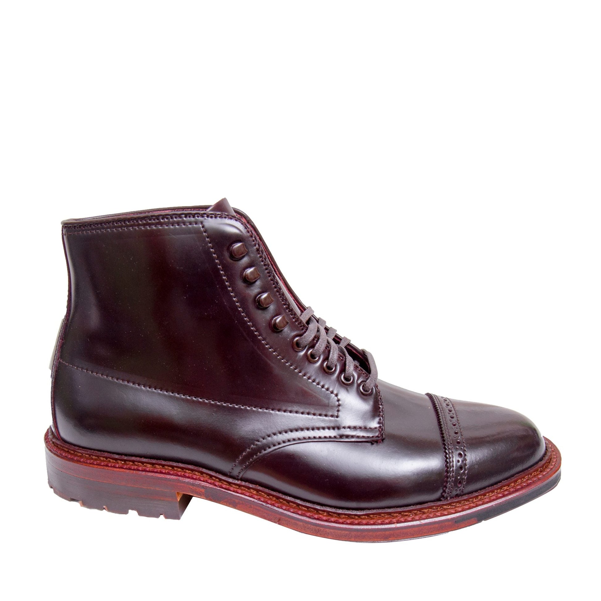 The Alden Madison D6861HC Jumper Boot in Color 8 Shell Cordovan is a dark brown leather ankle boot with a polished finish, featuring a cap toe, Speed Hook Lacing, and a robust sole with contrasting stitching and a reddish-brown welt.