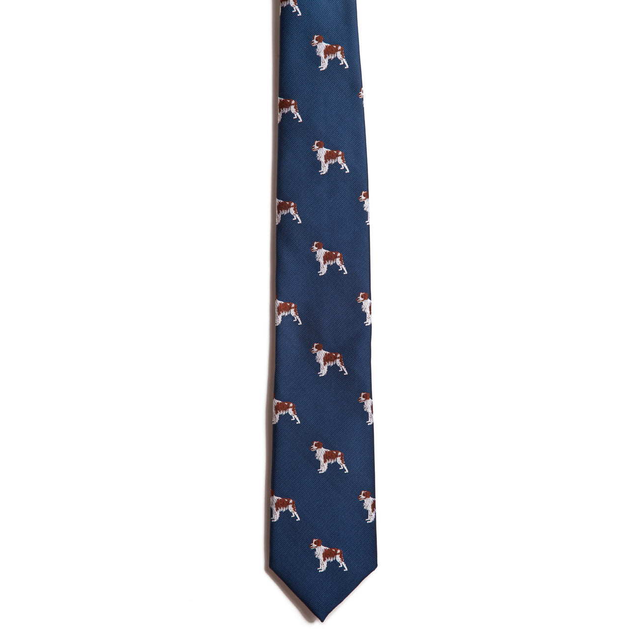 The Alden Madison Brittany Spaniel tie is a blue silk jacquard featuring a stylish repeating pattern of white and brown Brittany Spaniels evenly spaced across the fabric.