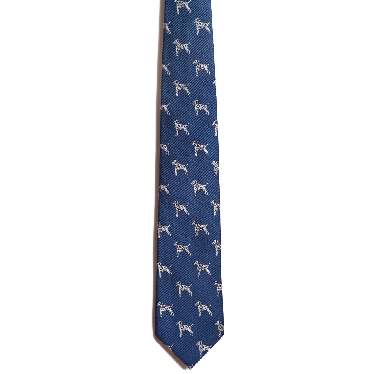 The Alden Madison Dalmatian is a blue silk necktie with evenly spaced small white dog illustrations, inspired by Dalmatians, displayed against a white background.
