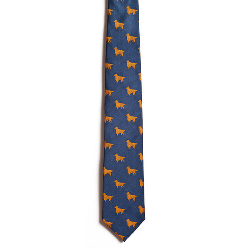 The “Golden Retriever” by Alden Madison is a blue jacquard silk necktie with a repeating pattern of small orange dog silhouettes—perfect for adding playful elegance to any outfit.