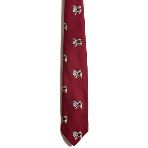 The Alden Madison Keeshond is a maroon silk jacquard necktie with a repeating pattern of small, side-facing embroidered dogs on a plain white background.