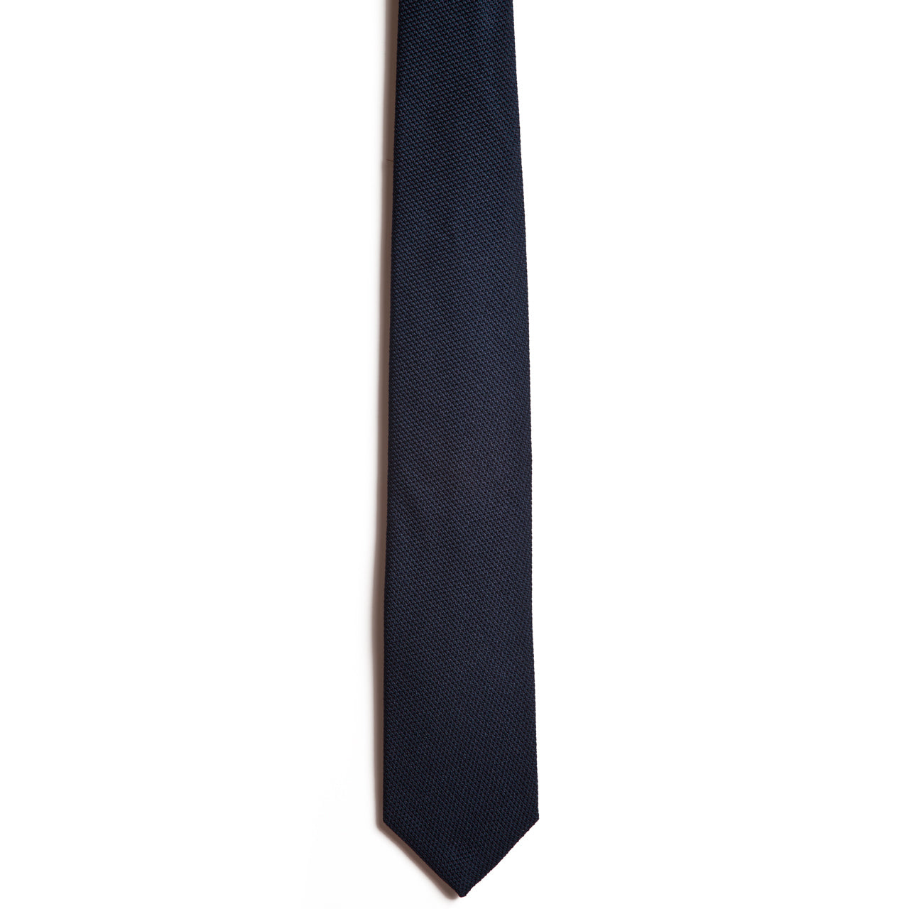 The Alden Madison Navy tie is handmade from Italian silk in dark navy blue with a subtle textured pattern on white. Its straight design and pointed tip add elegance to any attire.