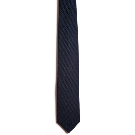 The Alden Madison Navy tie is handmade from Italian silk in dark navy blue with a subtle textured pattern on white. Its straight design and pointed tip add elegance to any attire.