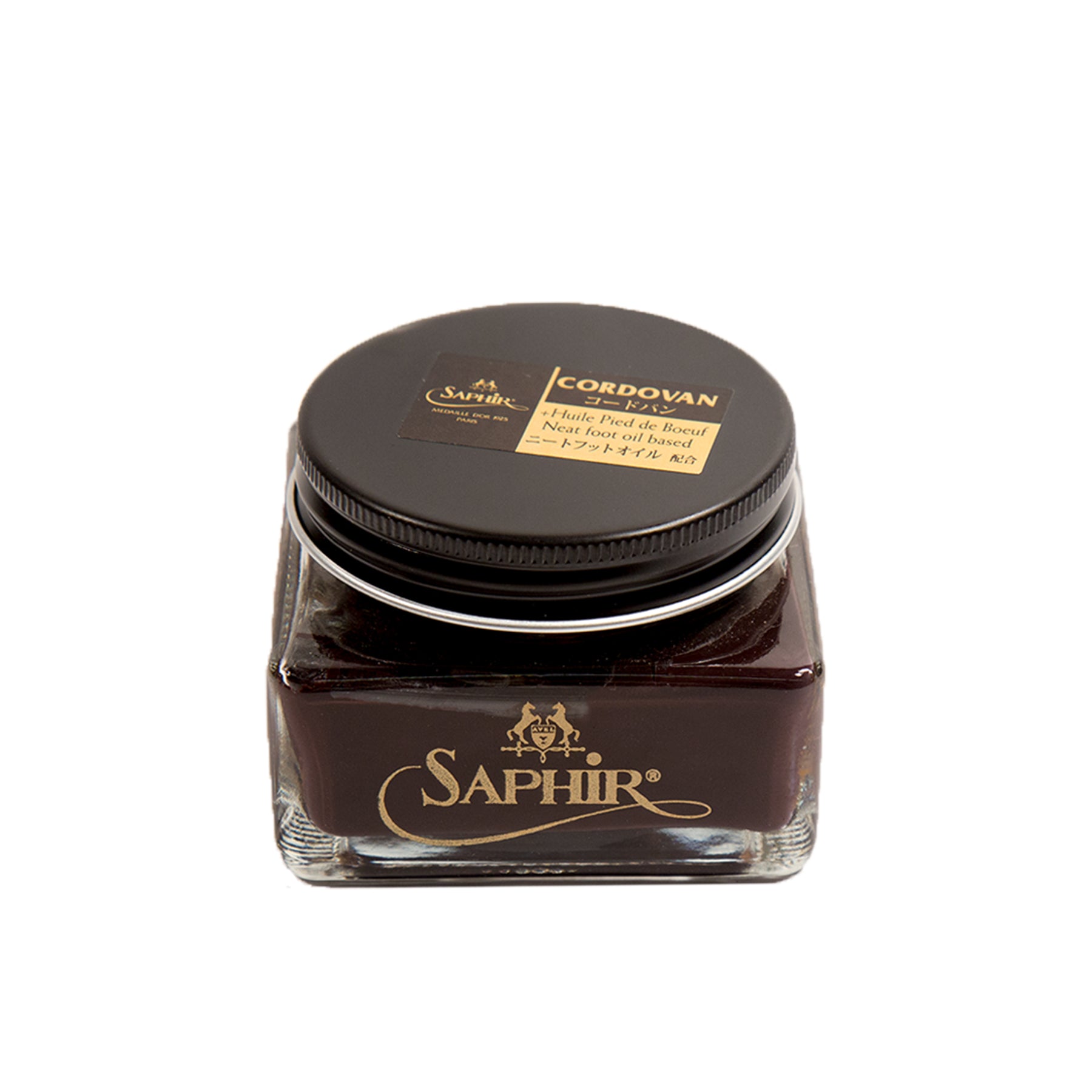 A glass jar of Alden Madison Saphir Cordovan Cream with a black lid is ideal for leather care. It contains a rich, dark brown polish specifically for Shell Cordovan Leather, featuring the brand name and product type elegantly in gold and beige text on the lid.